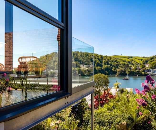 Glass-fronted gem in Kingswear, blending mid-century charm with stunning river and sea views in Kingswear. Sue Vaughton Photography